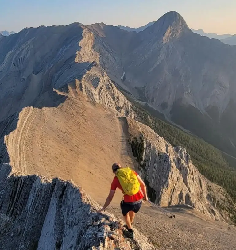 A climber following ridge from Gap Peak on the way to Mount Fable with morning light enhancing the view.