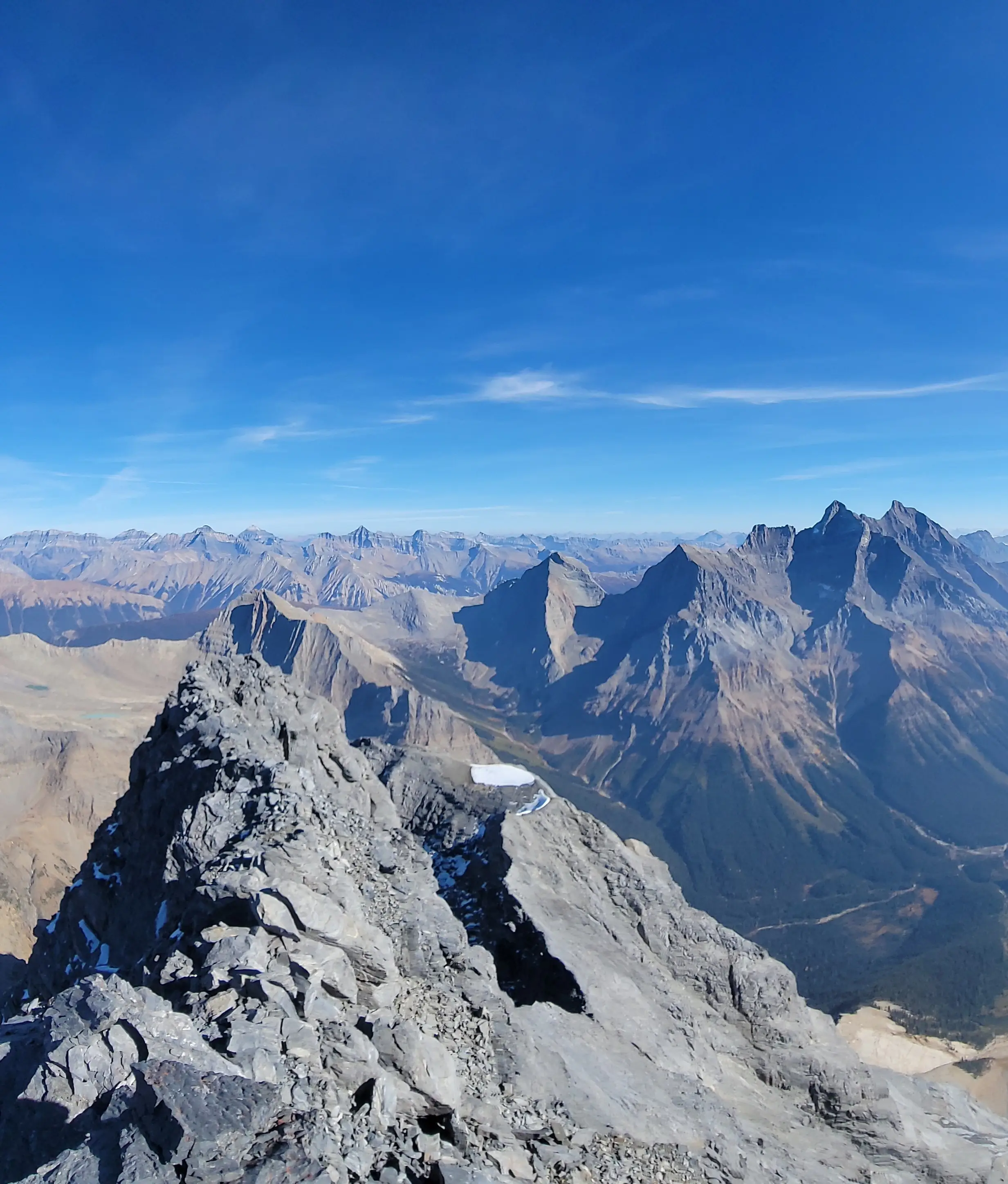 Views from the summit of Chancellor Peak towards Lake Louise with The Goodsirs and other giant peaks visible.