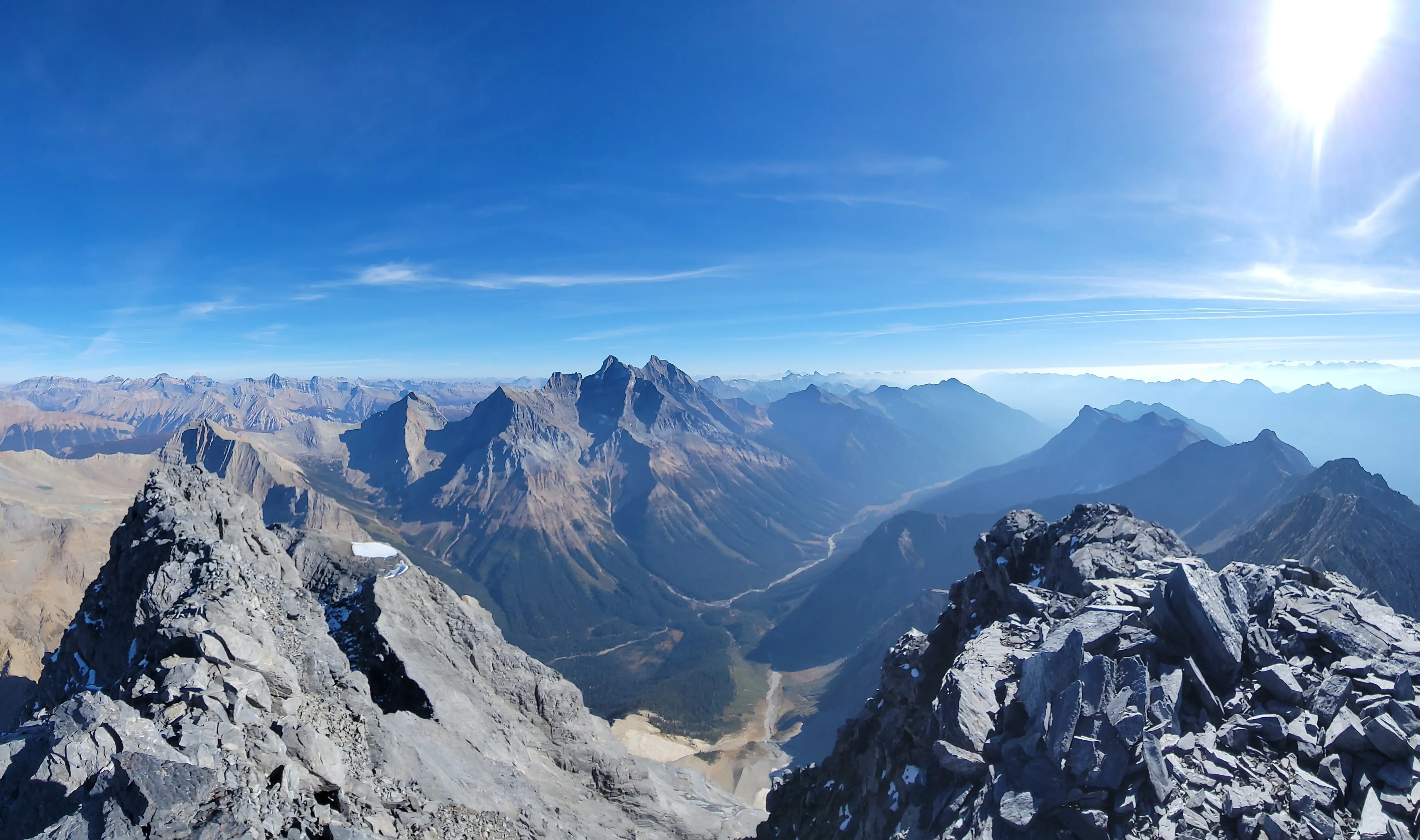 Views from the summit of Chancellor Peak with the valley bottom far below and The Goodsirs visible on the other side.